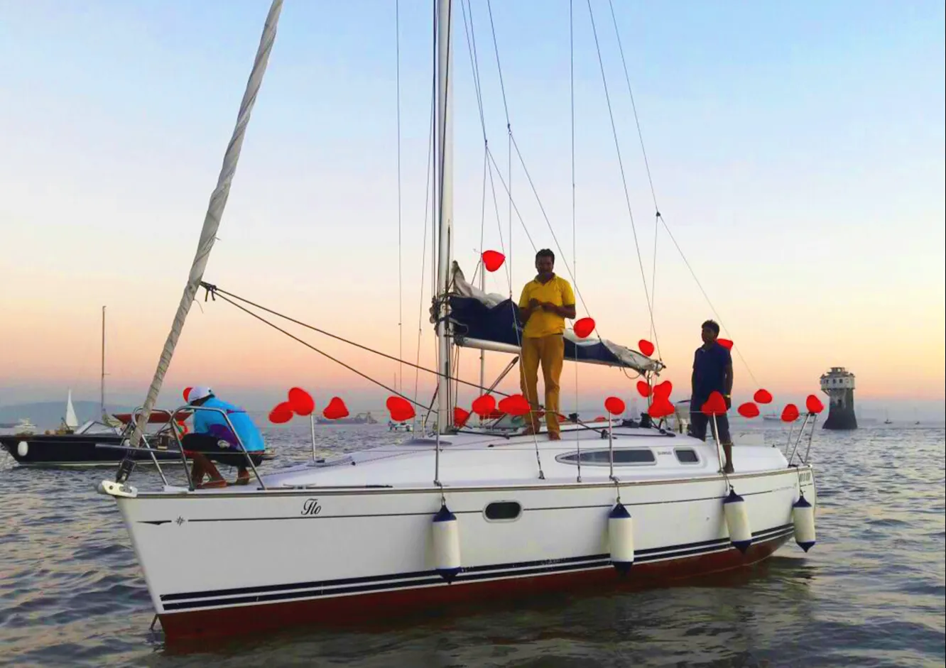 Guests on a sailing boat deck, Mumbai harbour